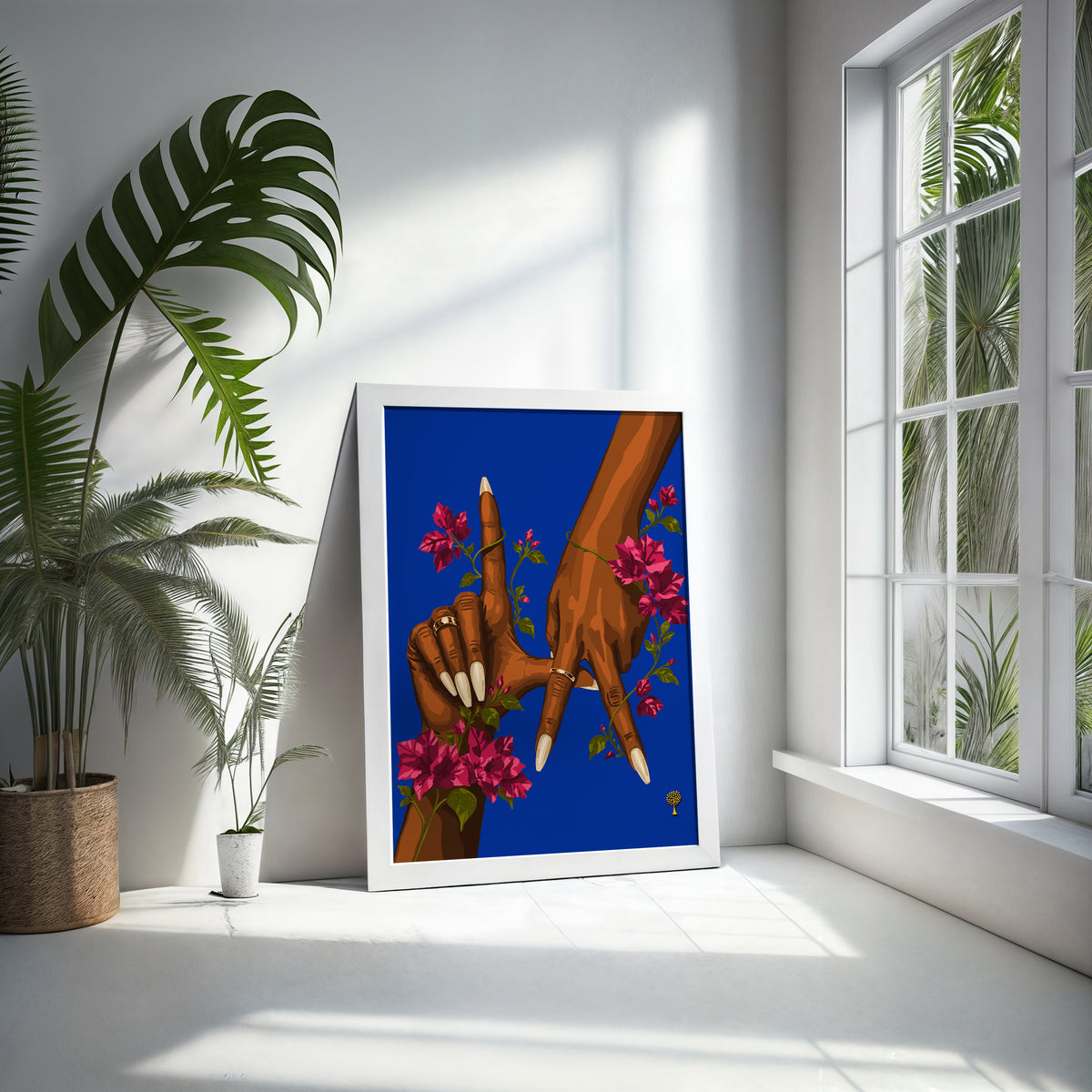 LA Print in a white frame leaning against a bright white wall beside palm and monstera plants